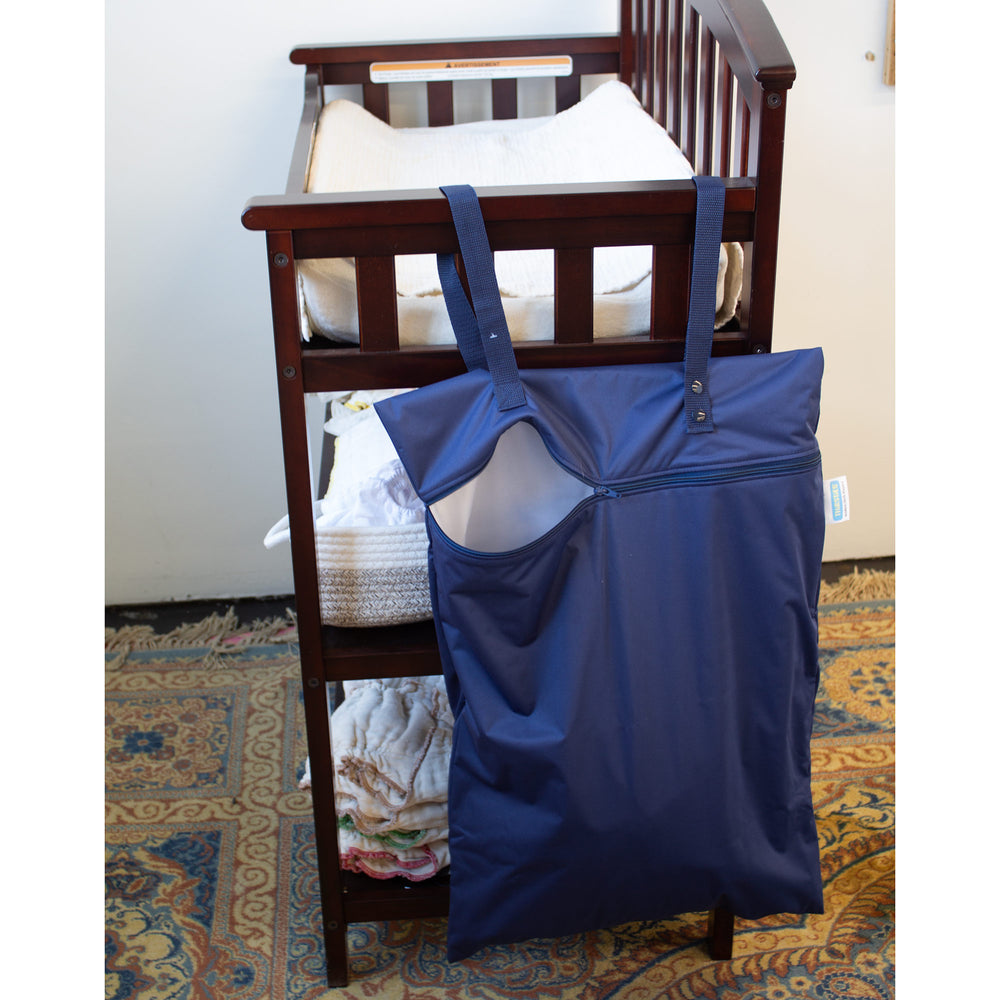 Thirsties hanging wet cloth diaper bag navy on changing table