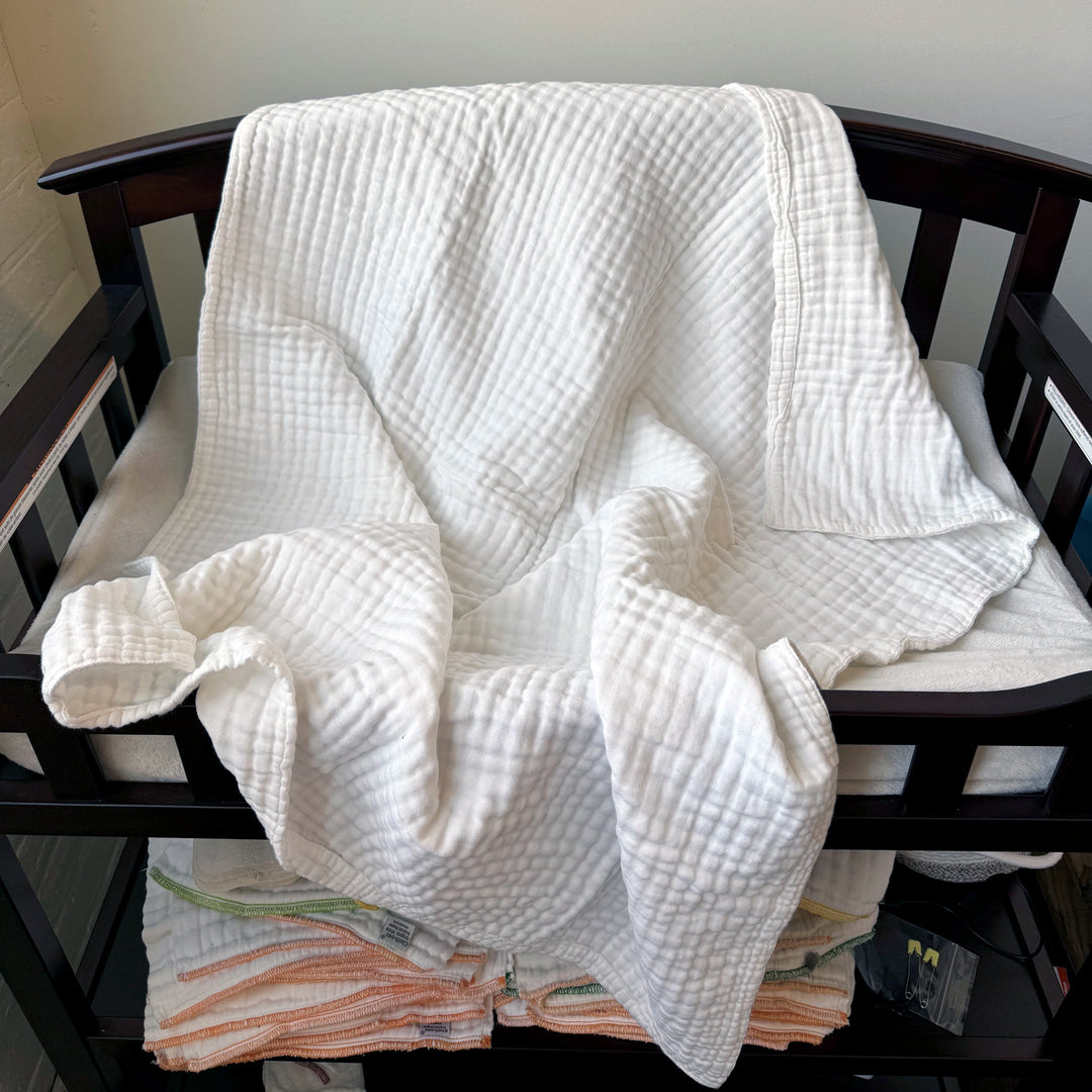 muslin crib blanket on a changing table