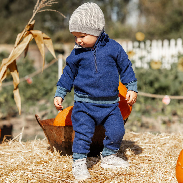 blue Disana wool pants on a toddler