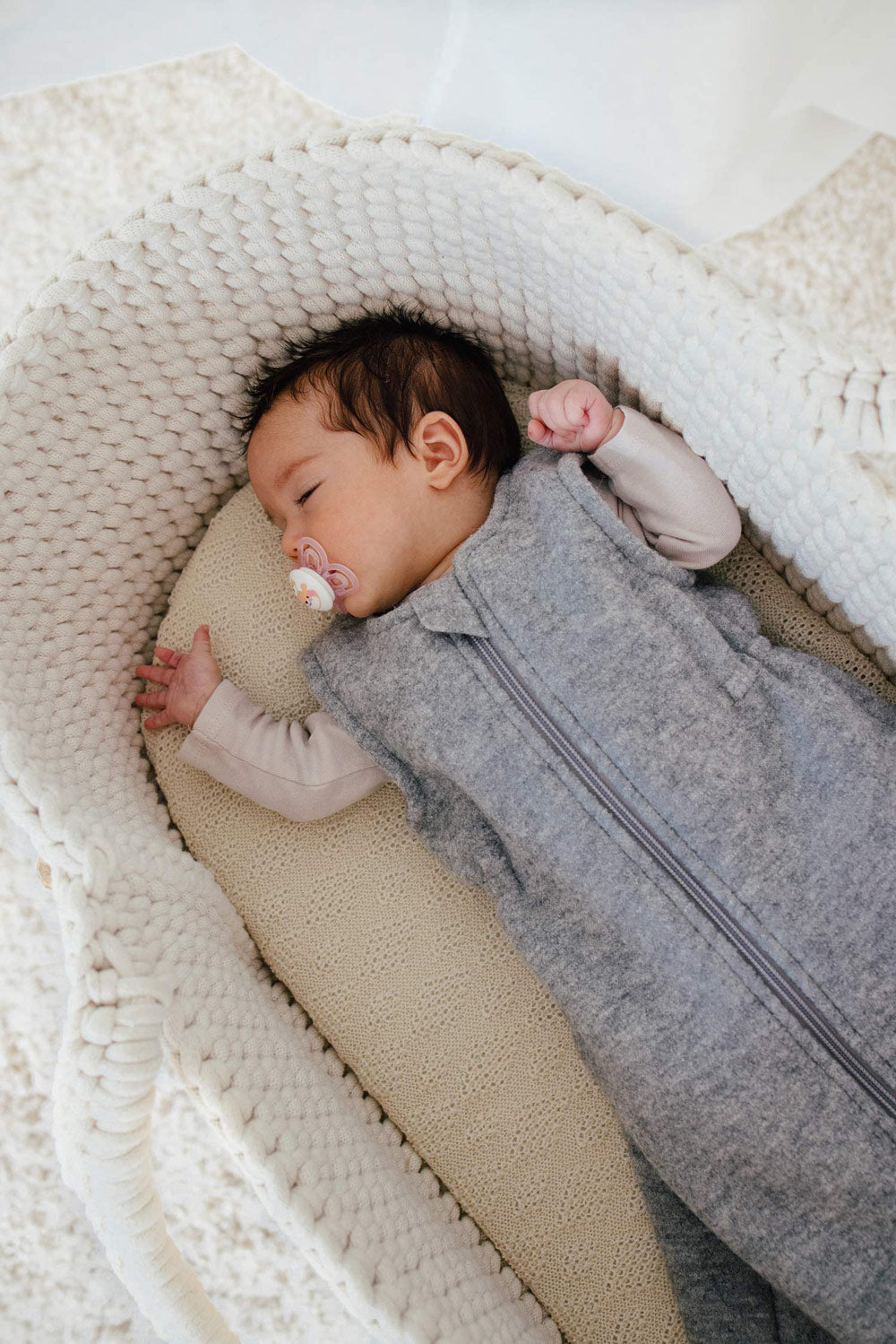 baby in  a wool sleep sack