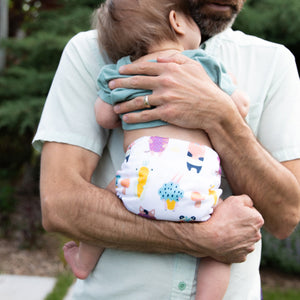 dad holding baby in Thirsties cloth diapers
