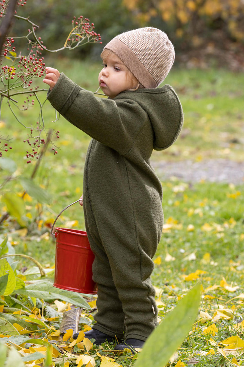 Baby in a wool snowsuit Disana zip overall