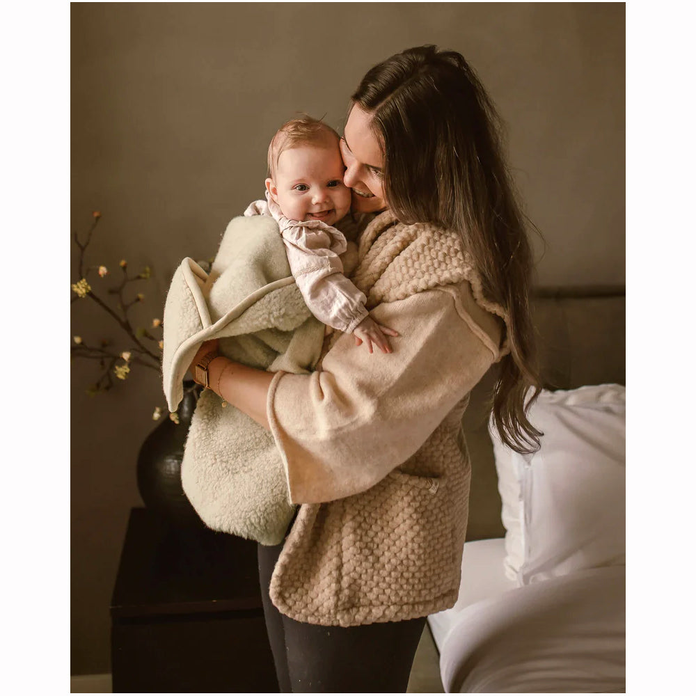 mom and baby in wool swaddle
