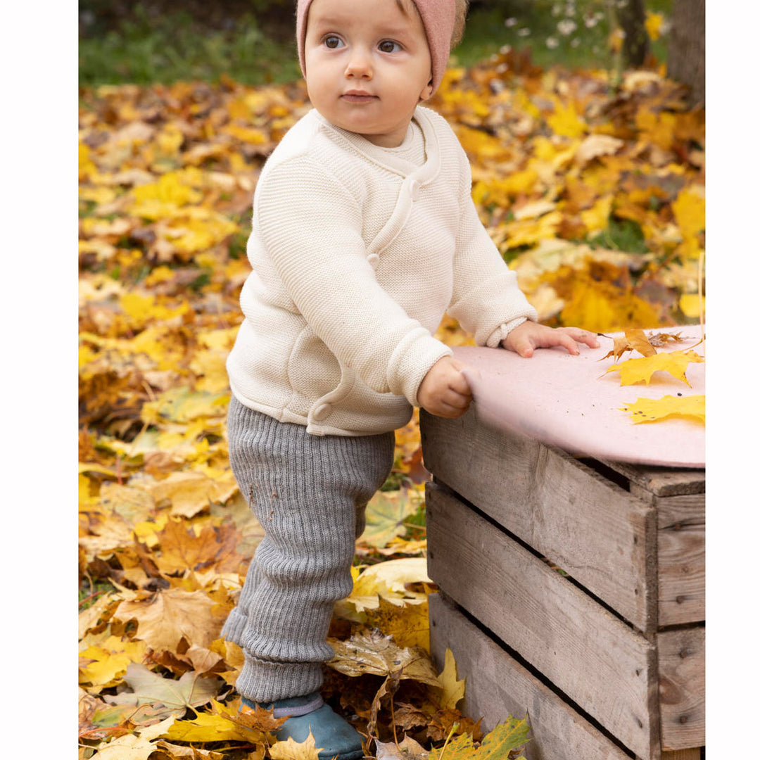 disana wool leggings on a baby standing outside