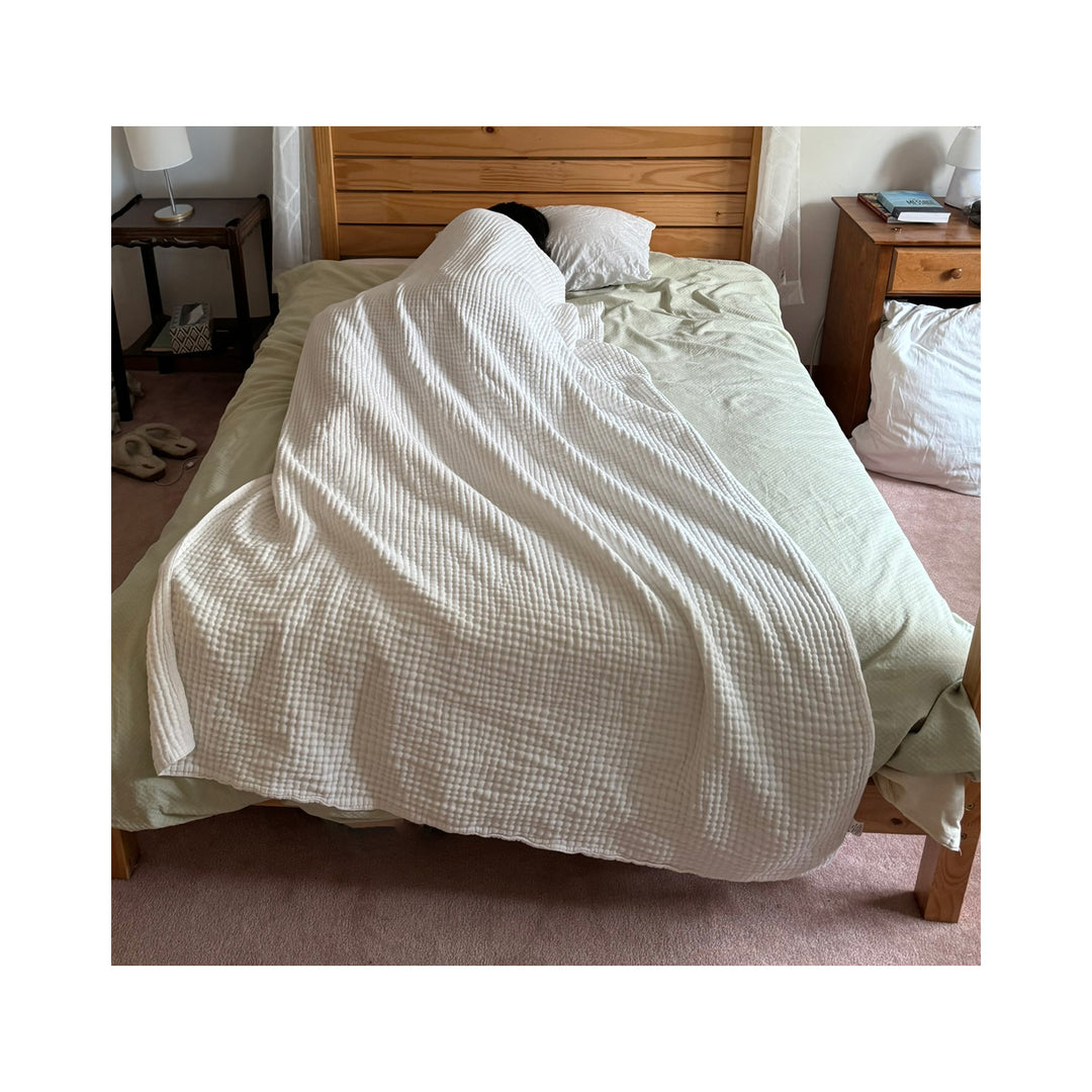 muslin blanket on a bed