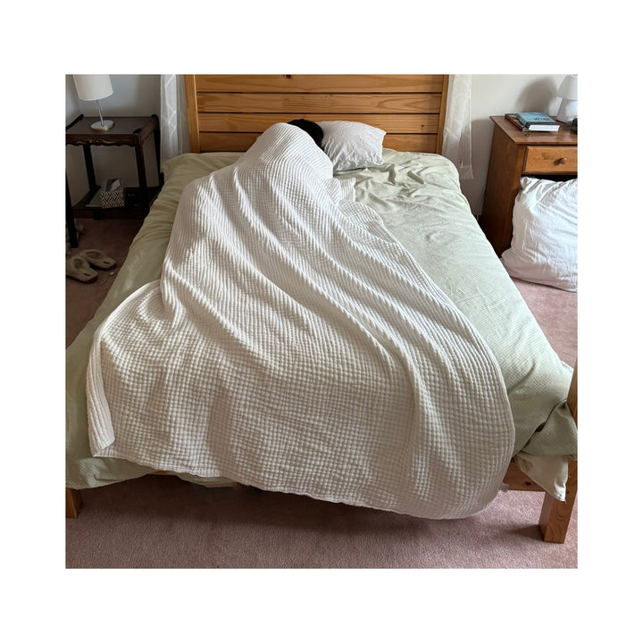 muslin blanket on a bed