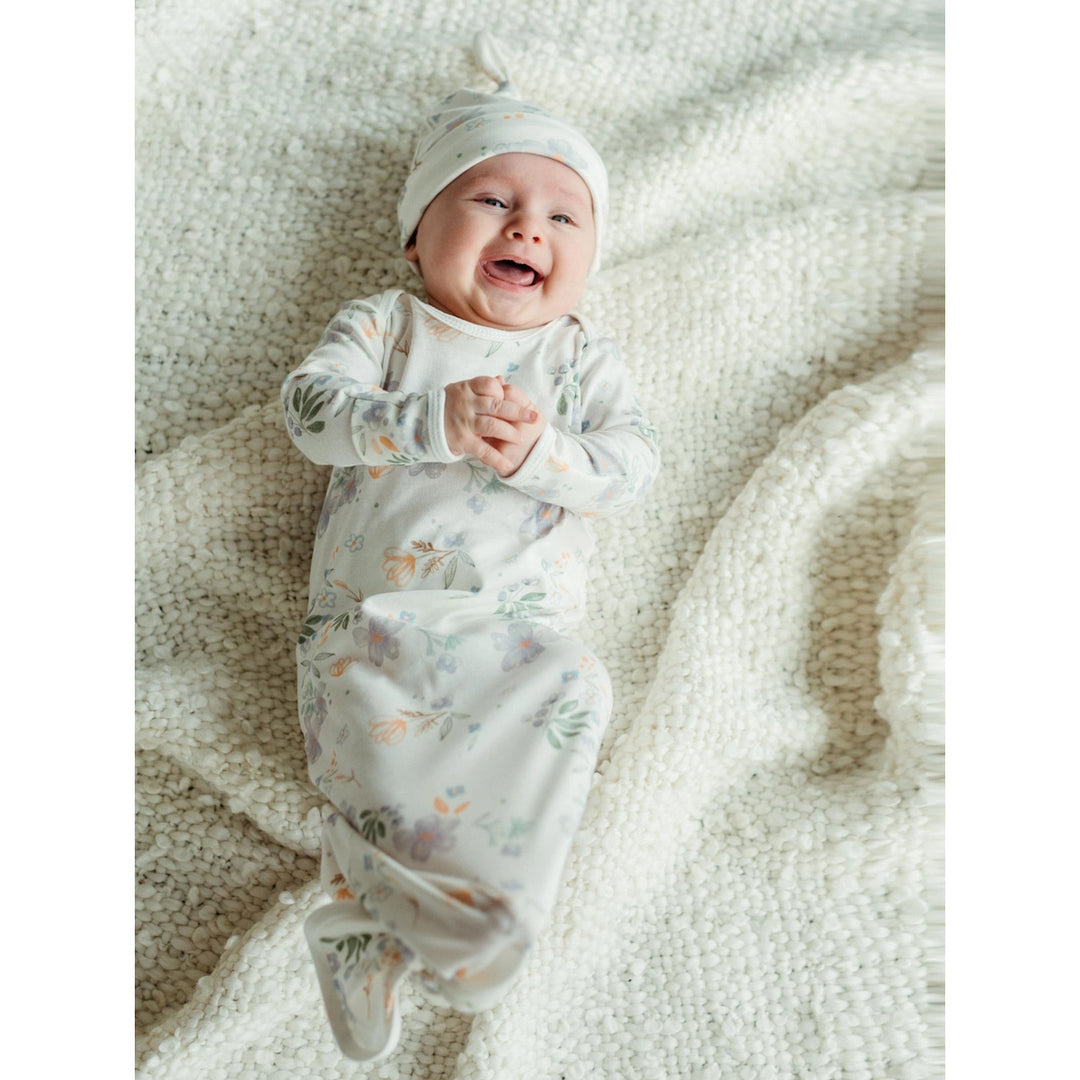 knotted baby gown and cap on a baby