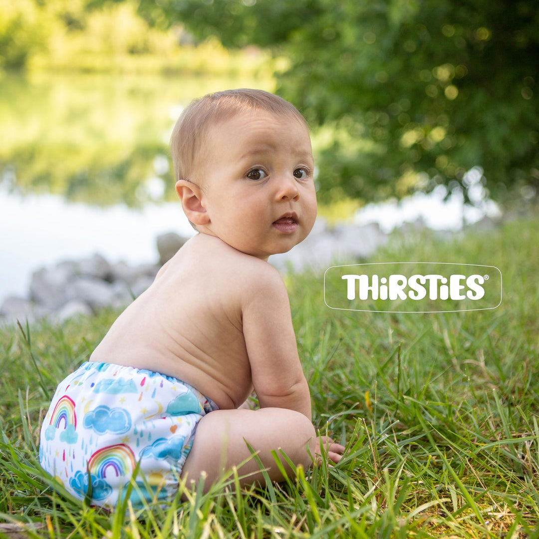 Baby in Thirsties natural all in on cloth diaper in grass