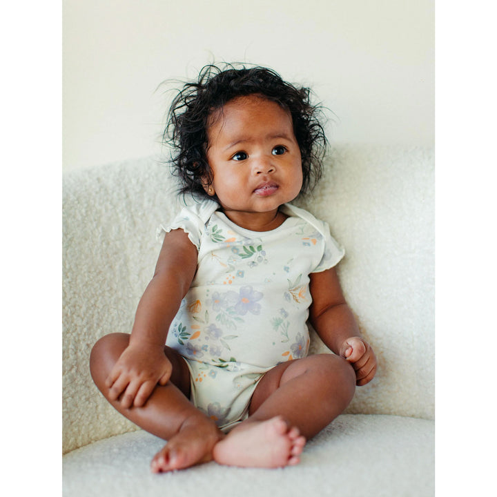 organic cotton onesie on a baby girl