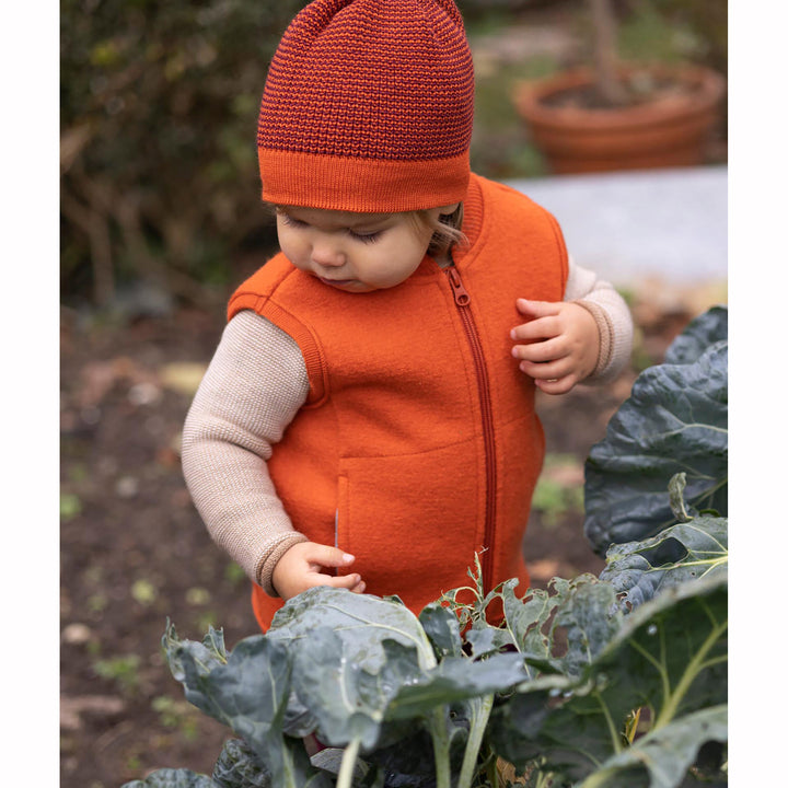 Disana wool vest orange on a baby